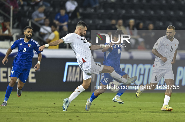 Ameed Mahajneh of Palestine battles for the ball with Yosef Alshammari of Kuwait during the FIFA World Cup 2026 Qualification 3rd Round grou...