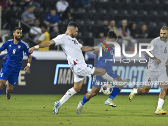 Ameed Mahajneh of Palestine battles for the ball with Yosef Alshammari of Kuwait during the FIFA World Cup 2026 Qualification 3rd Round grou...