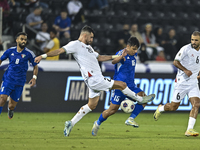 Ameed Mahajneh of Palestine battles for the ball with Yosef Alshammari of Kuwait during the FIFA World Cup 2026 Qualification 3rd Round grou...