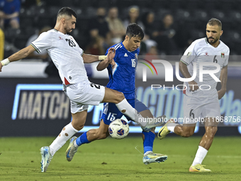 Ameed Mahajneh of Palestine battles for the ball with Yosef Alshammari of Kuwait during the FIFA World Cup 2026 Qualification 3rd Round grou...