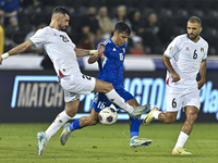 Ameed Mahajneh of Palestine battles for the ball with Yosef Alshammari of Kuwait during the FIFA World Cup 2026 Qualification 3rd Round grou...