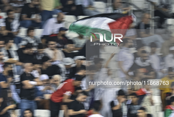 Fans of Palestine cheer during the FIFA World Cup 2026 Asian Qualifiers third round group B match between Palestine and Kuwait at Jassim Bin...