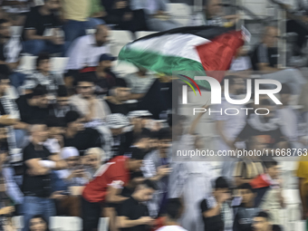 Fans of Palestine cheer during the FIFA World Cup 2026 Asian Qualifiers third round group B match between Palestine and Kuwait at Jassim Bin...