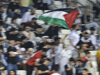 Fans of Palestine cheer during the FIFA World Cup 2026 Asian Qualifiers third round group B match between Palestine and Kuwait at Jassim Bin...