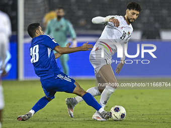 Wessam Abouli of Palestine battles for the ball with Athbi Saleh of Kuwait during the FIFA World Cup 2026 Qualification 3rd Round group B ma...