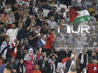 Fans of Palestine cheer during the FIFA World Cup 2026 Qualification 3rd Round group B match between Palestine and Kuwait at Jassim Bin Hama...