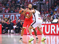 Evan Fournier of Olympiacos Piraeus competes with Leandro Bolmaro of EA7 Emporio Armani Milan during the Euroleague, Round 3 match between O...