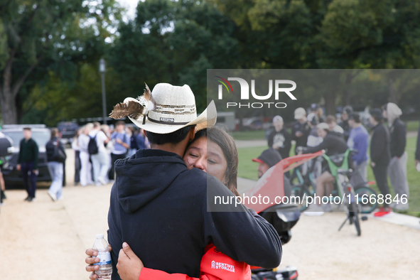 A woman is comforted by someone after Indigenous demonstrators clash with police near the U.S. Capitol in Washington, D.C. on October 15, 20...