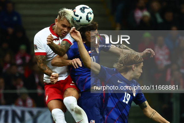 Kamil Piatkowski of Poland, Ante Budimir and Borna Sosa of Croatia during UEFA Nations League football match Poland - Croatia at National St...