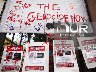 Pro-Palestinian banners are hanging on a fence during occupational strike in the yard of Jagiellonian University in Krakow, Poland on Octobe...