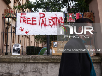 Pro-Palestinian banners are hanging on a fence during occupational strike in the yard of Jagiellonian University in Krakow, Poland on Octobe...