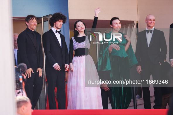 Sean Baker, Mikey Madison, and Mark Eydelshteyn attend the red carpet for the premiere of Anora during the 77th Festival de Cannes in Cannes...