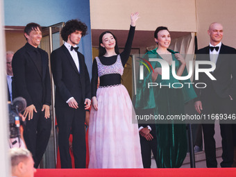 Sean Baker, Mikey Madison, and Mark Eydelshteyn attend the red carpet for the premiere of Anora during the 77th Festival de Cannes in Cannes...