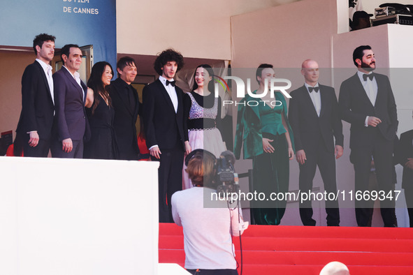 Sean Baker, Mikey Madison, and Mark Eydelshteyn attend the red carpet for the premiere of Anora during the 77th Festival de Cannes in Cannes...