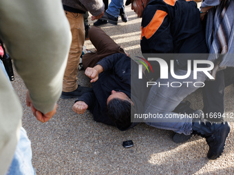 An Indigenous demonstrator falls to the ground during a clash with police near the U.S. Capitol in Washington, D.C. on October 15, 2024 afte...