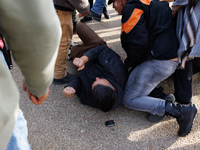 An Indigenous demonstrator falls to the ground during a clash with police near the U.S. Capitol in Washington, D.C. on October 15, 2024 afte...