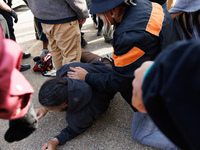 An Indigenous demonstrator falls to the ground during a clash with police near the U.S. Capitol in Washington, D.C. on October 15, 2024 afte...