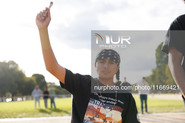 An Indigenous demonstrator holds burning sage near the U.S. Capitol in Washington, D.C. on October 15, 2024. after U.S. Park Police attempte...