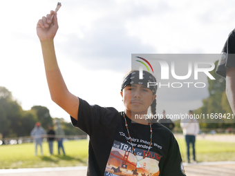 An Indigenous demonstrator holds burning sage near the U.S. Capitol in Washington, D.C. on October 15, 2024. after U.S. Park Police attempte...