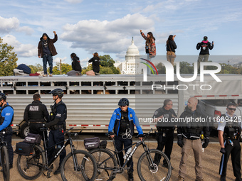 Police surround a horse trailer after Indigenous demonstrators clash with police near the U.S. Capitol in Washington, D.C. on October 15, 20...