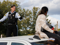 A U.S. Park Police officer speaks with an Indigenous demonstrator sitting atop a vehicle attached to a horse trailer near the U.S. Capitol i...