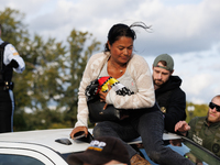 A U.S. Park Police officer speaks with an Indigenous demonstrator sitting atop a vehicle attached to a horse trailer near the U.S. Capitol i...