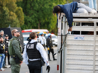 U.S. Park Police officers speak with an Indigenous demonstrator sitting atop a horse trailer near the U.S. Capitol in Washington, D.C. on Oc...