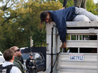 U.S. Park Police officers speak with an Indigenous demonstrator sitting atop a horse trailer near the U.S. Capitol in Washington, D.C. on Oc...