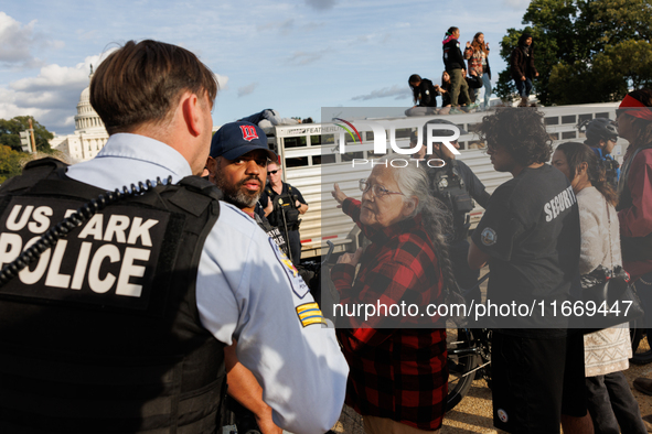 U.S. Park Police officers speak with an Indigenous demonstrator near the U.S. Capitol in Washington, D.C. on October 15, 2024 after U.S. Par...