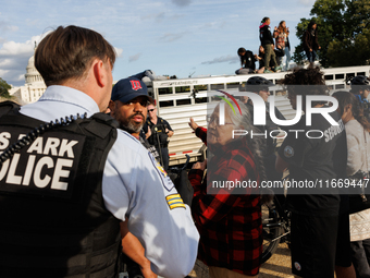 U.S. Park Police officers speak with an Indigenous demonstrator near the U.S. Capitol in Washington, D.C. on October 15, 2024 after U.S. Par...