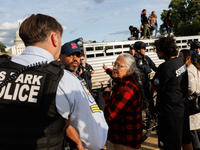 U.S. Park Police officers speak with an Indigenous demonstrator near the U.S. Capitol in Washington, D.C. on October 15, 2024 after U.S. Par...