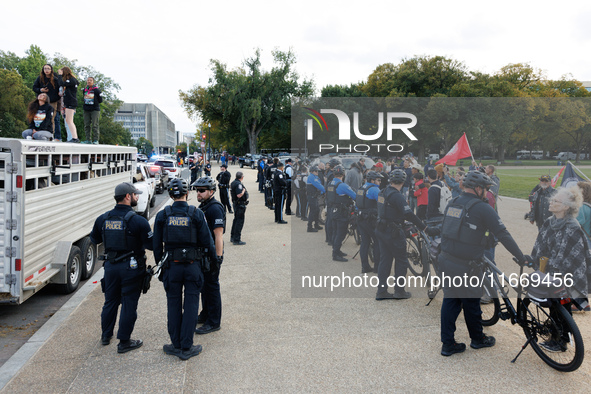 Police surround a horse trailer after Indigenous demonstrators clash with police near the U.S. Capitol in Washington, D.C. on October 15, 20...