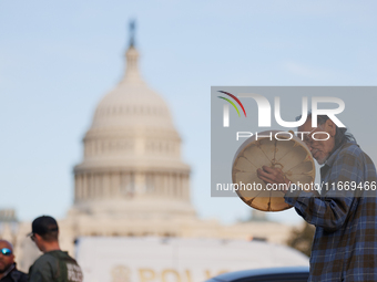 An Indigenous demonstrator plays a drum near the U.S. Capitol in Washington, D.C. on October 15, 2024. after U.S. Park Police attempted to c...