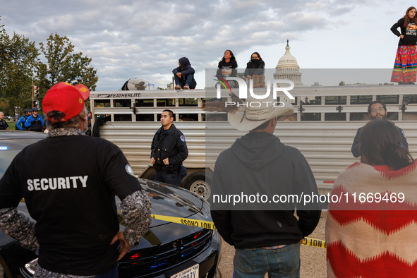 Police surround a horse trailer after Indigenous demonstrators clash with police near the U.S. Capitol in Washington, D.C. on October 15, 20...