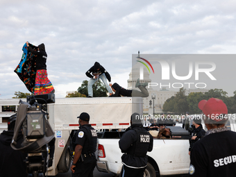 Indigenous demonstrators leave from atop a horse trailer near the U.S. Capitol in Washington, D.C. on October 15, 2024 after a standoff with...