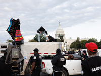 Indigenous demonstrators leave from atop a horse trailer near the U.S. Capitol in Washington, D.C. on October 15, 2024 after a standoff with...