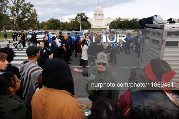 Police surround a horse trailer after Indigenous demonstrators clash with police near the U.S. Capitol in Washington, D.C. on October 15, 20...