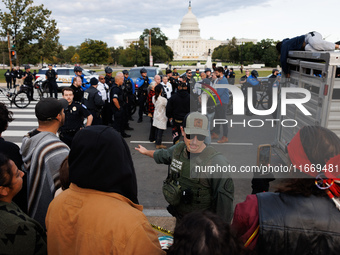 Police surround a horse trailer after Indigenous demonstrators clash with police near the U.S. Capitol in Washington, D.C. on October 15, 20...