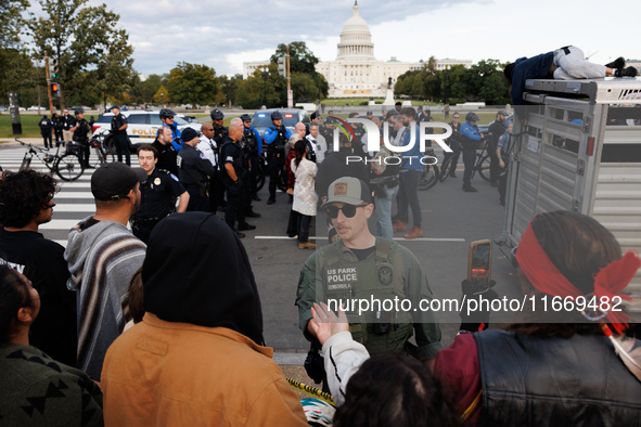 Police surround a horse trailer after Indigenous demonstrators clash with police near the U.S. Capitol in Washington, D.C. on October 15, 20...