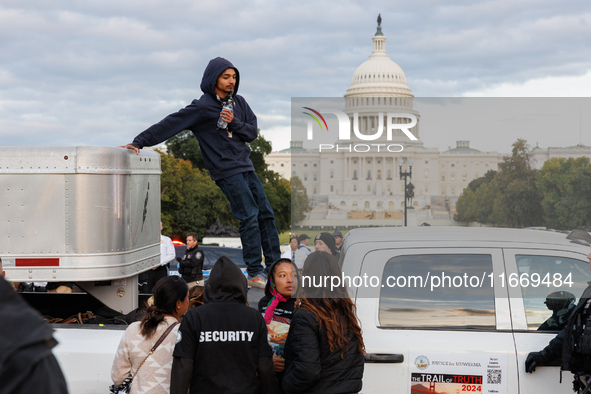 Indigenous demonstrators leave from atop a horse trailer near the U.S. Capitol in Washington, D.C. on October 15, 2024 after a standoff with...