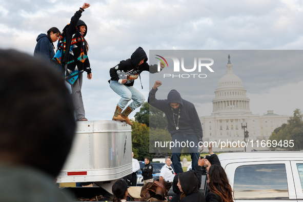 Indigenous demonstrators leave from atop a horse trailer near the U.S. Capitol in Washington, D.C. on October 15, 2024 after a standoff with...