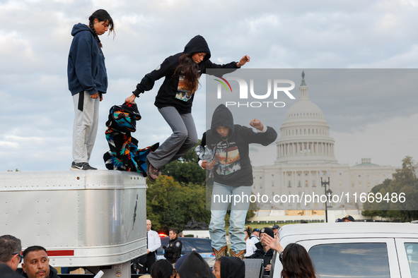 Indigenous demonstrators leave from atop a horse trailer near the U.S. Capitol in Washington, D.C. on October 15, 2024 after a standoff with...