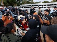 Indigenous demonstrators comfort one another near the U.S. Capitol in Washington, D.C. on October 15, 2024. after clashes with U.S. Park Pol...