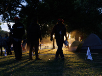 The sun sets behind an encampment erected by members of the Muwekma Ohlone Tribe of the San Francisco Bay Area, along with other tribal grou...