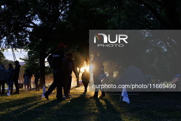 The sun sets behind an encampment erected by members of the Muwekma Ohlone Tribe of the San Francisco Bay Area, along with other tribal grou...