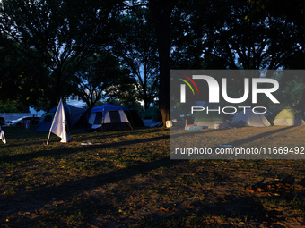 The sun sets behind an encampment erected by members of the Muwekma Ohlone Tribe of the San Francisco Bay Area, along with other tribal grou...