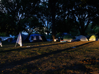 The sun sets behind an encampment erected by members of the Muwekma Ohlone Tribe of the San Francisco Bay Area, along with other tribal grou...