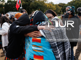 Indigenous demonstrators comfort one another near the U.S. Capitol in Washington, D.C. on October 15, 2024. after clashes with U.S. Park Pol...