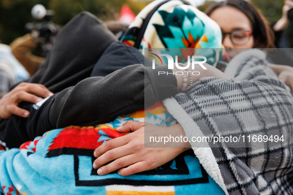 Indigenous demonstrators comfort one another near the U.S. Capitol in Washington, D.C. on October 15, 2024. after clashes with U.S. Park Pol...