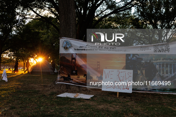 The sun sets behind an encampment erected by members of the Muwekma Ohlone Tribe of the San Francisco Bay Area, along with other tribal grou...